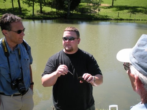 Dr. Cristopher Owen holds a large freshwater mussel